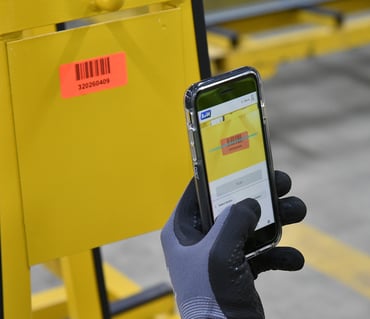 A smartphone and the A+W Smart Companion software are used to scan a barcode from a pane of glass.